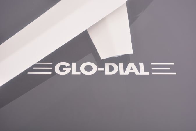 Glo-Dial Clock Company, Los Angeles, California, neon gallery wall clock, electric driven, time only movement with large 25.5in black dial, bold straight white hands, Arabic numerals and orange lighted neon perimeter