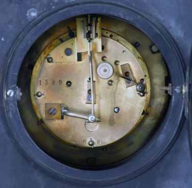 Marti & Cie, Paris, mantel clock, 8 day, time and strike, spring driven movement with visible Brocot escapement in an incised black slate case with red marble insets and molding, engraved sunk dial with black slate chapter ring with Roman numerals.