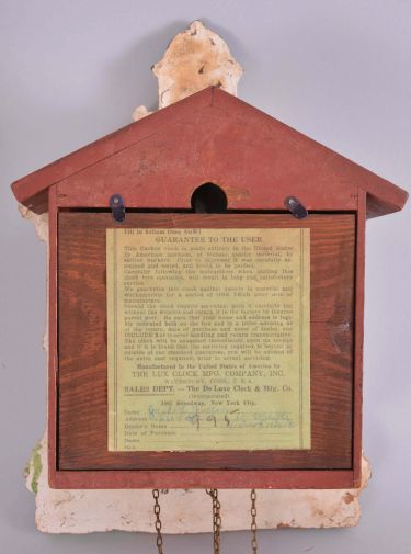 Lux Manufacturing Company, Waterbury, Conn., "Town Hall" wall clock, 30 hour, time and strike, weight driven movement, architectural case in the form of a public building with bell tower, Roman numeral dial, scroll form weights, book and gavel pendulum.