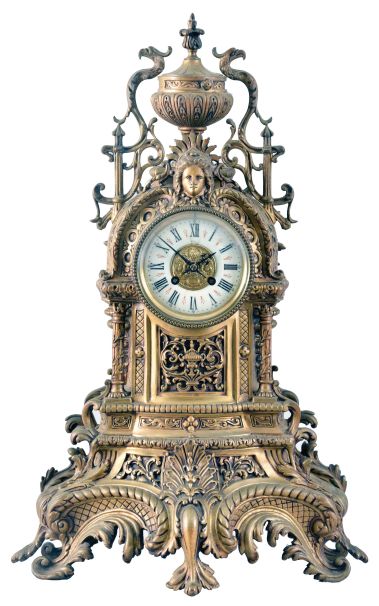 France, Mantel Clock with porcelain roman numeral dial and decorative cast center, blued-steel hands, complicated classical-styled cast brass case with urn finial at the top flanked by griffins, a female goddess of the sun life mask surmounting the dial, four fluted columns supporting the whole and a leaf and scroll base with cross hatching and four scroll-leafed feet, round brass French eight day movement with rack hour striking on a gong and pendulum.