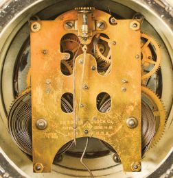 Ansonia Clock Co., New York, "Bard" figural mantel clock, 8 day, time and strike, spring driven movement with visible brocot escapement in a spelter case on an enameled cast iron base, white enamel dial with Roman numerals.