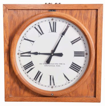 Standard Electric Time Co., Springfield, Mass., "Master Clock" wall clock, electrically driven, time only movement producing electrical impulse to drive a slave or slaves, one of which is included. The clock is housed in a heavy oak case and has painted metal dial.