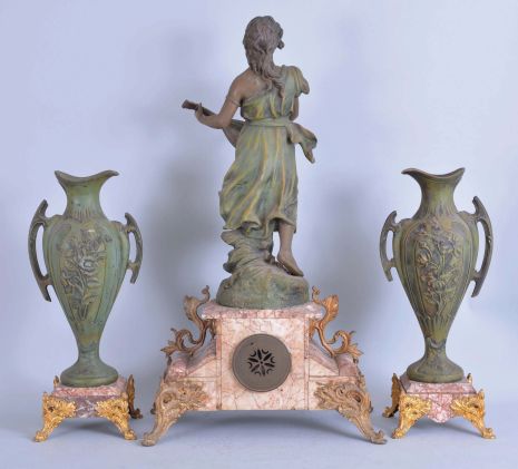 France, Variegated Pink Marble Figural Clock Garniture, the clock with off-white arabic numeral dial within a brass bezel and beveled glass set within the marble case with scroll work dial surround, on raised feet and and plinth for the statue titled "La Cigale" a sculpture first presented by Sylvain Kinsburger, the patinated figure of a young maiden no doubt playing the 