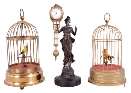Singing birds- 2 (Two) Singing birds and one swinging mystery clock: German made yellow signing birds in brass cages and one Junghans-style reproduction mystery clock inspired by the "Diana" model.
