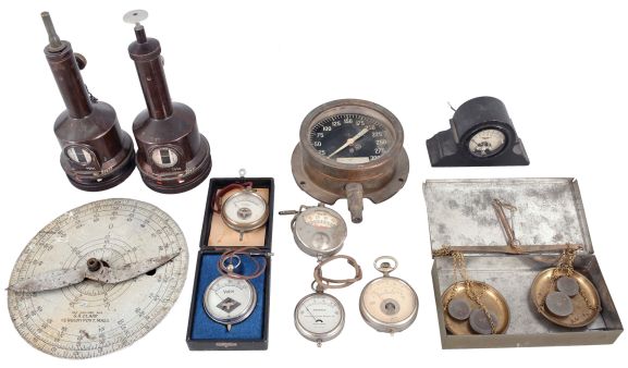 Instruments & Gauges- 11 (Eleven) assorted device for measuring including four small volt meters, two pocket ammeters, a steam pressure gauge, two German detonation timers, a balance scale, and circular rule/scale of unknown purpose.