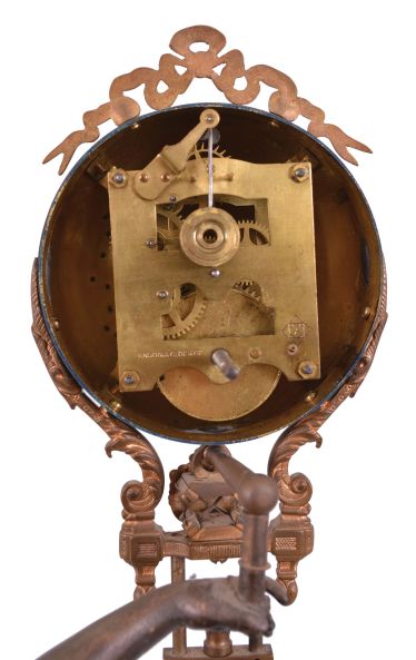 Ansonia Clock Co., New York, "Huntress" swinging mystery clock, 8 day, time only, spring-driven movement mounted inside a brass sphere with cast ribbon ornament and applied Arabic numerals, Louis XV style hands, the lower section in gridiron style with smaller sphere at the bottom, and held aloft by a patinated spelter figure of a young woman carrying game birds.