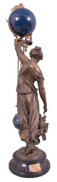 Ansonia Clock Co., New York, "Huntress" swinging mystery clock, 8 day, time only, spring-driven movement mounted inside a brass sphere with cast ribbon ornament and applied Arabic numerals, Louis XV style hands, the lower section in gridiron style with smaller sphere at the bottom, and held aloft by a patinated spelter figure of a young woman carrying game birds.