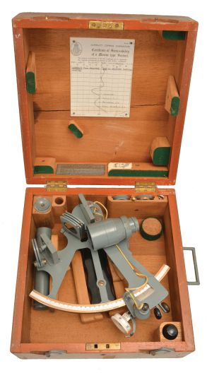 Hughes & Son Ltd., London, 6.5 inch sextant, pierced metal frame with gray finish, signed brass arc with inset silvered scale, the graduations from -5 to 130, micrometer drum adjustment, index lamp, multiple shades for horizon and index mirrors, sighting scopes, and plastic handle with battery compartment, all in finger-jointed mahogany box with a certificate from the Admiralty Compass Observatory dated 1955.