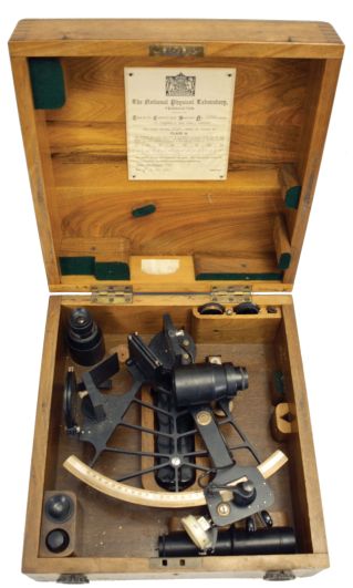 H. Hughes & Son Ltd., London, 7 inch sextant, pierced metal frame with black finish, signed brass arc with inset silvered scale, the graduations from -5 to 125, micrometer drum adjustment, index lamp, multiple shades for horizon and index mirrors, sighting scopes, and plastic handle with battery compartment, all in finger-jointed walnut box with a certificate from the National Physical Laboratory with a stamp from its director, C.G. Darwin dated 1947.