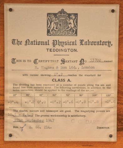 H. Hughes & Son Ltd., London, 7 inch sextant, pierced metal frame with black finish, signed brass arc with inset silvered scale, the graduations from -5 to 125, micrometer drum adjustment, index lamp, multiple shades for horizon and index mirrors, sighting scopes, and plastic handle with battery compartment, all in finger-jointed walnut box with a certificate from the National Physical Laboratory with a stamp from its director, C.G. Darwin dated 1947.