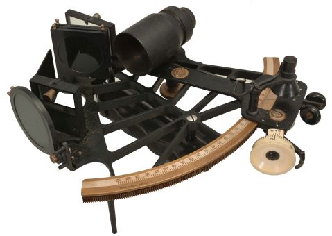 H. Hughes & Son Ltd., London, 7 inch sextant, pierced metal frame with black finish, signed brass arc with inset silvered scale, the graduations from -5 to 125, micrometer drum adjustment, index lamp, multiple shades for horizon and index mirrors, sighting scopes, and plastic handle with battery compartment, all in finger-jointed walnut box with a certificate from the National Physical Laboratory with a stamp from its director, C.G. Darwin dated 1947.