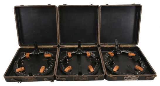 Azimuth Circles- 3 (Three) U.S. Navy Azimuth Circles: National Electrical Machine Shops, Washington, DC, for Bureau of Ships, "U.S. Navy Azimuth Circle, Mark 3, Mod. 2", each with black metal ring with an outside diameter of 10.25 inches, beveled inner lip graduated counterclockwise in degrees, two reflecting prisms with associated bubble levels, concave mirror, dark glass reflector vane behind far sight vane with framed vertical hairline, near sight vane, two turned finger lugs, all in molded bakelite cases.