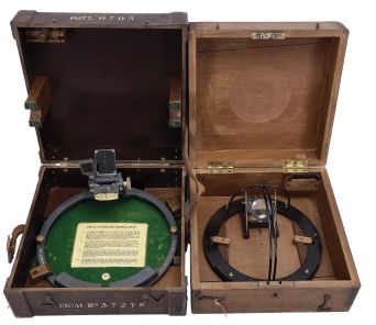 Azimuth Circles- 2 (Two) U.S. Navy Azimuth Circles: (1) "Pattern 6703 Gyro Azimuth Circle", gray painted brass ring with 10 inch outside diameter, dark glass reflector vane, reflecting prism with vertical hairline and knurled adjusting screw, two sun shades, felt-lined bakelite box with instructions fastened to base. (2) T. S. & J. D. Negus, New York, Nagus patened azimuth circle, 8 inch outside diameter, three-sided prisim with vertical hairline, bubble level, and bearing magnifier, red glass sun shade, all in a finger-jointed mahogany box, patented 1901.