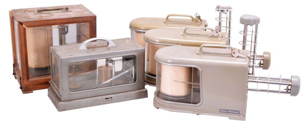 Instruments- 5 (Five) Barographs: three with green plasic cases and spring-driven motors by Jules Richard of France, one in a gray steel case with spring-driven motor by Friez of Baltimore, and one in a glazed wood case with dedication plaque and electrically driven motor by R. Fuess of Berlin.