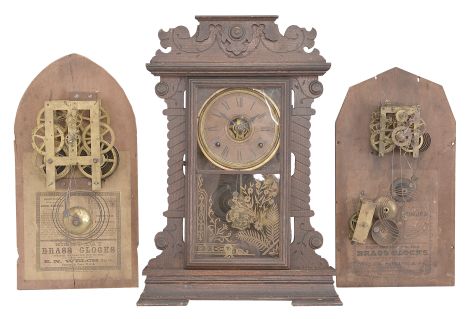 Clocks- 3 (Three): (1) Waterbury Clock Co., "Kingsland" clock, 8 day, time and strike, spring driven movement in an oak case, c1906; (2) George B. Owen, Winsted, Conn., mantel clock, 8 day, time and strike, spring driven movement in a walnut case, c1885; (3) Seth Thomas Clock Co., "New York" collage series clock, 8 day, time and strike with alarm in an oak case, c1909. Lot also includes two mantel clock backboards with paper labels and mounted movements, one 8 day and on 20 hour, by E.N. Welch and Welch Spring & Co.
