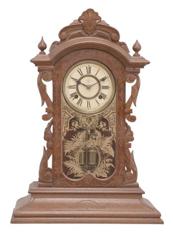 Ansonia Clock Co., New York, NY, "Broadway" shelf clock, 8 day, time and strike, spring driven movement in a walnut and burled walnut veneer case with carved elements.