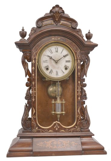 Ansonia Clock Co., New York, "Fifth Avenue", 8 day, time and strike, spring driven movement in a walnut and walnut burl veneer case with carved elements.
