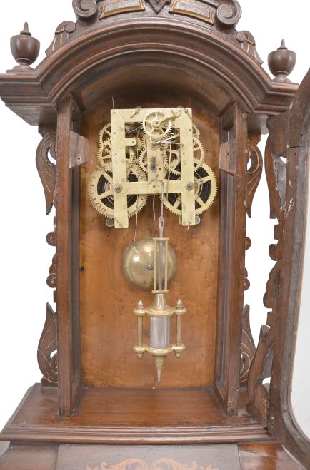 Ansonia Clock Co., New York, "Fifth Avenue", 8 day, time and strike, spring driven movement in a walnut and walnut burl veneer case with carved elements.