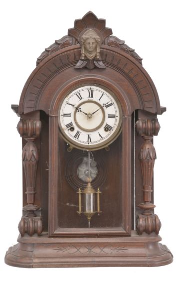 E.N. Welch, Forestville, Conn., unknown model, 8 day, time and strike, spring driven movement in a walnut case with full carved columns.