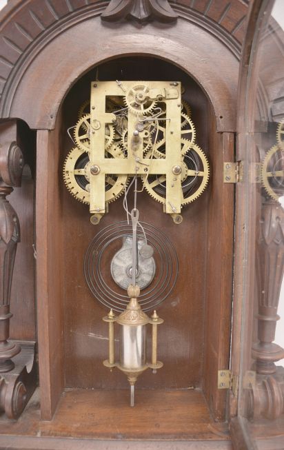 E.N. Welch, Forestville, Conn., unknown model, 8 day, time and strike, spring driven movement in a walnut case with full carved columns.