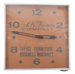 Modern Clock Advertising Co., Brooklyn, New York, outdoor store advertising clock, 120v AC electric motor-driven movement in an aluminium housing, the acrylic dial reading "A.K. Thomas Company / Office Furniture / Business Machines ".