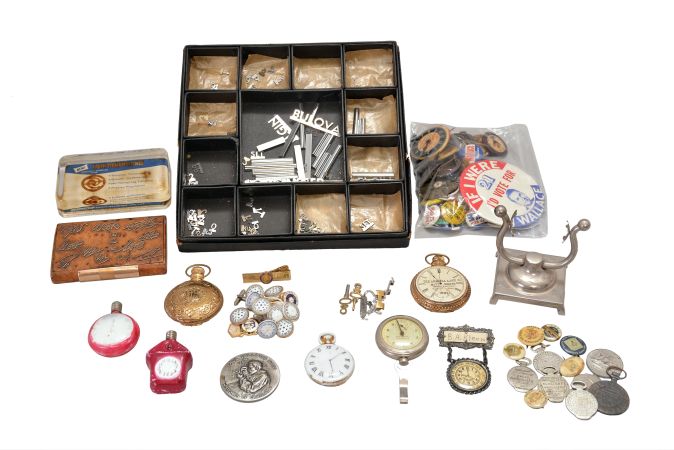 Large lot of political, fraternal, and advertising pinbacks, including Goldwater, Wallace, Nixon, Roosevelt, Eisenhower, Johnson, and others, together with a group of B.P.O.E. related buttons, and two advertising Sterling bicycles, and six advertising the watches of Ball & Co, South Bend, Hamilton and Hampden, and five case openers from various watch case manufacturers, together with a gold mounted, burl wood tobacco box, two clock themed Christmas lights, an Elgin Durabalance paperweight, display items for a jewelers watch case, and more