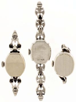 Wrist watches- 3 (Three): all ladys, the first an Omega, 17 jewel cal. 485 movement, baton marker metal dial, 14 karat white gold case, the next a Bulova, 23 jewel cal. 5AT movement, Arabic numeral metal dial, diamond set 14 karat white gold case, the last by Benrus, 17 jewel DZ20 movement, dot and baton marker metal dial, diamond set 14 karat white gold case and partial bracelet, 26.1g TW