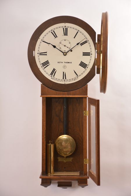 Seth Thomas Clock Co., Thomaston, Conn., "Regulator No. 2 Reissue", 8 day, weight brass movement wall timepiece. Case is numbered 3573 of 4000.