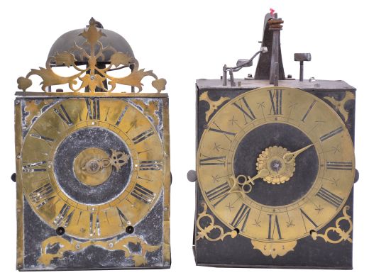 Clocks- 2 (Two) Early Comtoise: (1) France, Comtoise clock, 8 day, time and strike, weight driven movement with verge escapement, thread suspension with rear-hanging pendulum in a iron post and plate frame, brass chapter ring with engraved Roman numerals, applied spandrels and pivoted winding arbor shutters, single brass hand, topped by flat pierced brass fronton, first half of the 18th Century. (2) France, Comtoise clock, 8 day, time and strike with alarm, weight driven movement with verge escapement, thread suspension with rear-hanging pendulum in a iron post and plate frame, brass chapter ring with engraved Roman numerals, applied spandrels and pivoted winding arbor shutters, single brass hand, first half of the 18th Century.