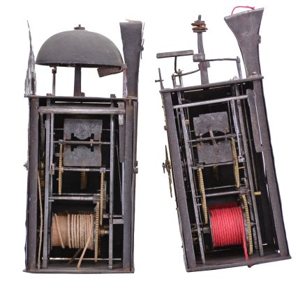 Clocks- 2 (Two) Early Comtoise: (1) France, Comtoise clock, 8 day, time and strike, weight driven movement with verge escapement, thread suspension with rear-hanging pendulum in a iron post and plate frame, brass chapter ring with engraved Roman numerals, applied spandrels and pivoted winding arbor shutters, single brass hand, topped by flat pierced brass fronton, first half of the 18th Century. (2) France, Comtoise clock, 8 day, time and strike with alarm, weight driven movement with verge escapement, thread suspension with rear-hanging pendulum in a iron post and plate frame, brass chapter ring with engraved Roman numerals, applied spandrels and pivoted winding arbor shutters, single brass hand, first half of the 18th Century.