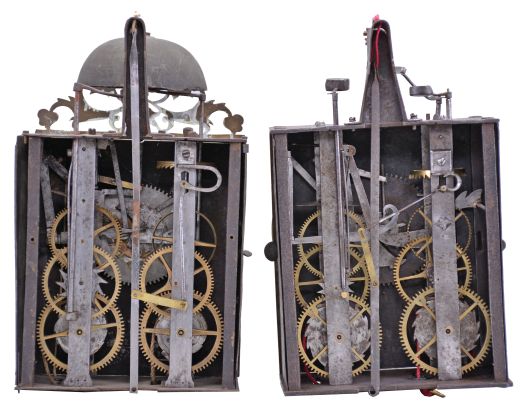 Clocks- 2 (Two) Early Comtoise: (1) France, Comtoise clock, 8 day, time and strike, weight driven movement with verge escapement, thread suspension with rear-hanging pendulum in a iron post and plate frame, brass chapter ring with engraved Roman numerals, applied spandrels and pivoted winding arbor shutters, single brass hand, topped by flat pierced brass fronton, first half of the 18th Century. (2) France, Comtoise clock, 8 day, time and strike with alarm, weight driven movement with verge escapement, thread suspension with rear-hanging pendulum in a iron post and plate frame, brass chapter ring with engraved Roman numerals, applied spandrels and pivoted winding arbor shutters, single brass hand, first half of the 18th Century.